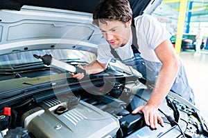 Auto mechanic working in car service workshop