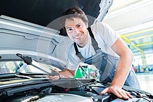 Auto mechanic working in car service workshop