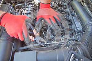 Auto mechanic working in garage. Auto Repair and care Concept