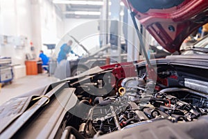 Auto mechanic working in garage. Concept car repair service