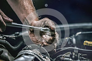 Auto mechanic working in garage. Repair service.