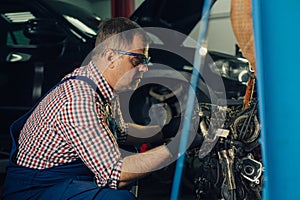 Auto mechanic working in garage. Repair service