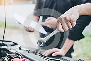 Auto mechanic working in garage Technician Hands of car mechanic working in auto repair Service and Maintenance car check