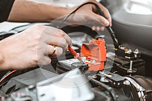 Auto mechanic working in garage Technician Hands of car mechanic working in auto repair Service and Maintenance check car battery