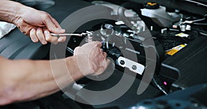 Auto mechanic working with wrench on vehicle engine in car service. maintenance and repair