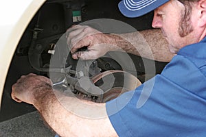 Auto Mechanic Works on Brakes