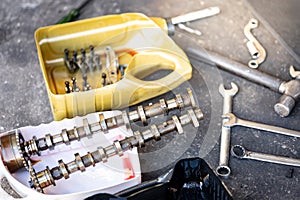 Auto parts in gallon cut in half with mechanical tools