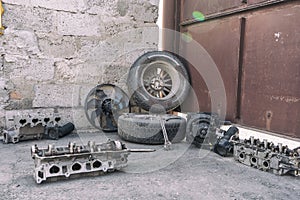 auto parts lie on asphalt in courtyard of private house