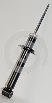 Auto parts. New car shock absorber on a light background