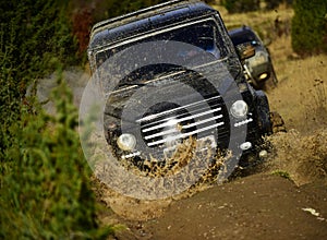 Auto racing on fall nature background. Competition, energy and motorsport concept. Car racing in autumn forest. Off road