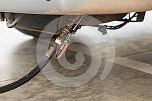 Auto refuel. Car at gas station being filled with fuel. The car is filling LPG with nozzles, Liquid Petroleum Gas service pump. Al