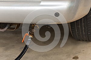 Auto refuel. Car at gas station being filled with fuel. The car is filling LPG with nozzles, Liquid Petroleum Gas service pump. Al