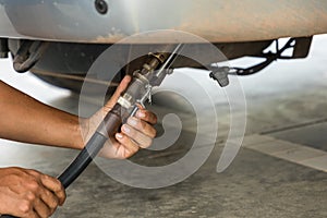 Auto refuel. Car at gas station being filled with fuel. The car is filling LPG with nozzles, Liquid Petroleum Gas service pump. Al