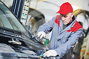 Auto repair service. Mechanic works with spanner