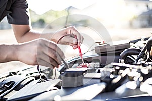 Auto repair technician has inspected the condition of the engine using ammeter,