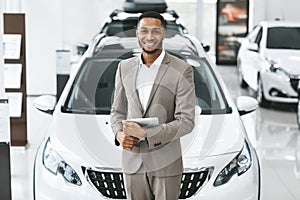 Auto Seller Man Smiling To Camera Standing In Automobile Center