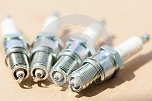 Auto service. Set of spark plugs as spare part of car.