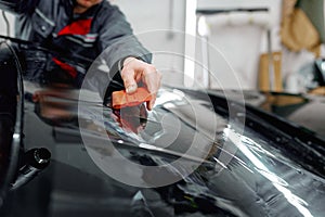Auto service worker coating luxury black car