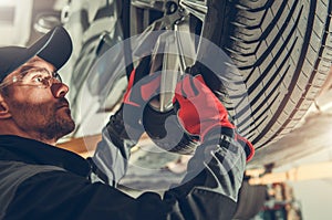 Auto Service Worker Replacing Car Tires