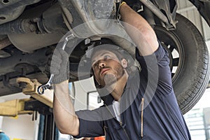 Auto services and Small business concepts. Auto mechanic hands using wrench to repair a car engine