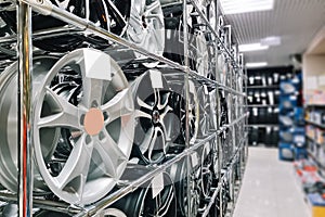 Auto shop selling car rims. Stand for sale of alloy wheels. Discounts at auto parts store.