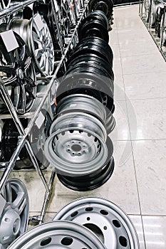 Auto shop selling car rims. Stand for sale of alloy wheels. Discounts at auto parts store.