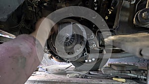 Auto technician dismantles used car pressure plate and clutch disc