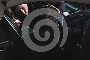 Auto thief looking to car interior