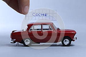 Auto word written on a piece of paper, Coche in Spanish photo