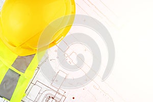 Autocad drawing, Architecture and construction, builder`s hard hat and safety vest on architectural blueprints