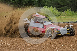 Autocross on a dusty road. Car in competition up the road on a d