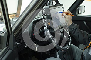 Autodiagnostics. Professional car mechanic working in a service station