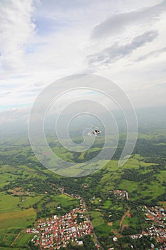 Autogyro flying over the tropical landscape