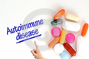 Autoimmune disease on white background near colorful pills or drugs photo