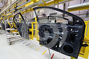 Car door on conveyor. Robotic equipment makes Assembly of car. Modern car Assembly at factory