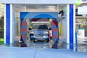 Automated car wash with a soapy truck photo