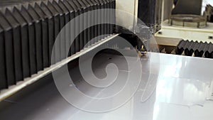 Automated CNC laser machine cuts stainless steel sheet. Laser cutting of metal