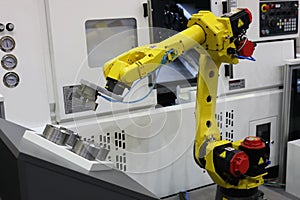Automated CNC machine loading with robotic arm photo