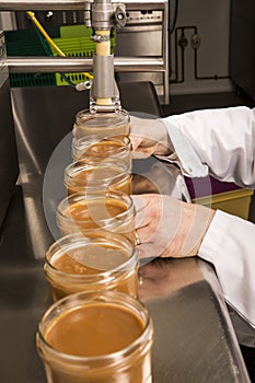 Automated food factory put caramel jam in jars