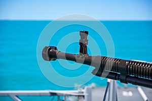 Automated machine gun on the deck of a military ship