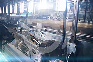 Automated machine tool in factory, part of conveyor belt close up as abstract industrial background
