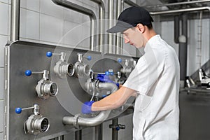 Automated milk production plant. The worker controls the production process on the farm.