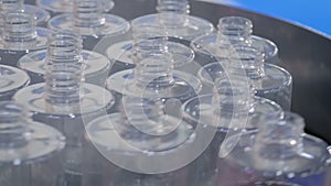 Automated pharma technology concept - rotating platform with empty glass bottles