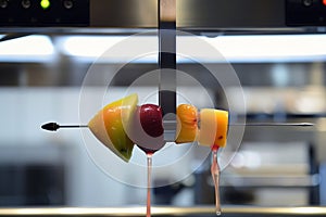 automated pincer with a fruit sorbet on a stick
