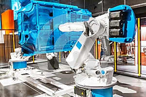 automated robotic arm working in car factory