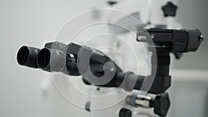 Automated scientific microscope close-up.