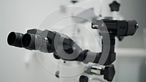 Automated scientific microscope close-up.