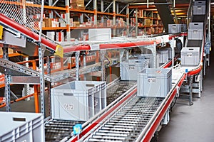 Automated warehouse. Boxes with spare parts moving on conveyer