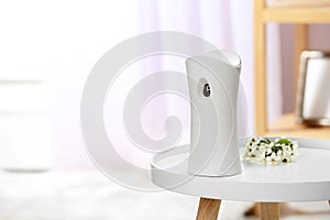 Automatic air freshener on table