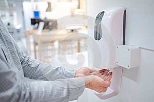 Automatic alcohol dispenser in office building